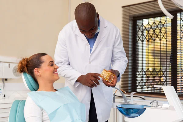 Dentist communicating with patient — communication as a dental malpractice risk management tool